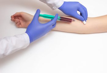 A doctor takes a biochemical blood test from a patient's vein for a blood test